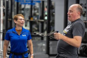 Trainer helping Adult with Strength Training in Foxboro, MA