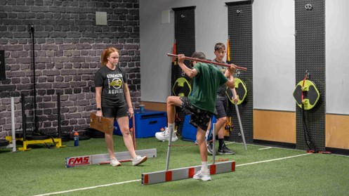 FMS movement test with dowel rod at Elite Sports Performance & Physical Therapy