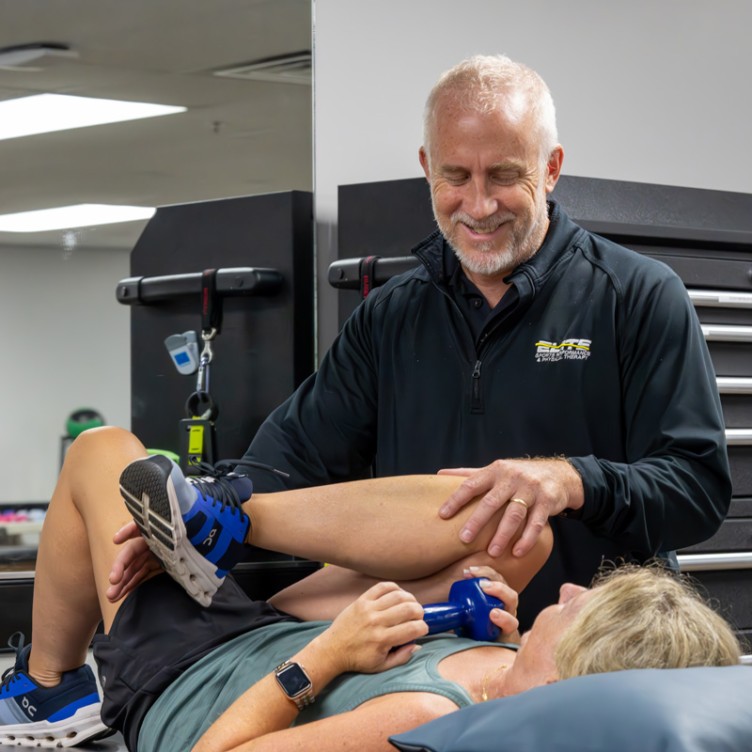 Therapist assisting leg stretch at Elite Sports Performance & Physical Therapy