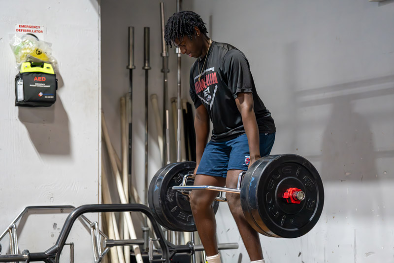 athlete performing hex bar deadlift
